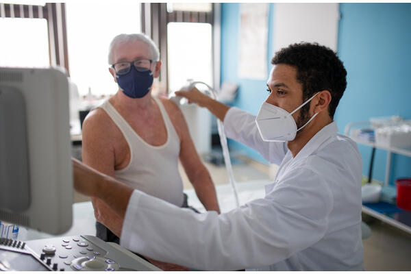 Young doctor examines a patient