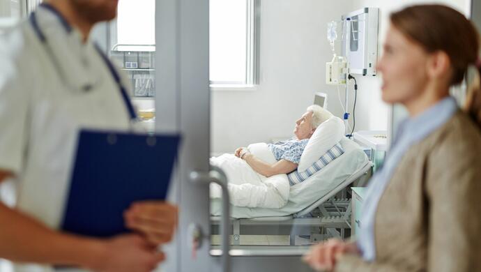 Women talking to Doctor to Visit Grandmother in Hospital