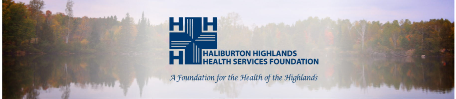 Landscape of trees in fall colours reflecting on a still lake with HHHS Foundation logo over top